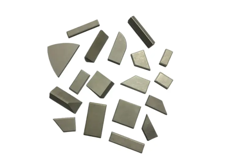 Premium tungsten carbide brazing tips in assorted shapes and sizes for woodworking and metal cutting tool fabrication.