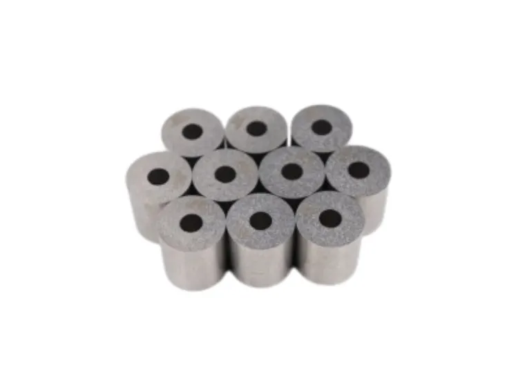 Stack of eleven cemented tungsten carbide die nibs in a sintered state.