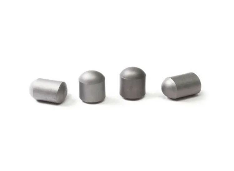 Four cemented tungsten carbide buttons and tips, including two with domed ballistic heads.