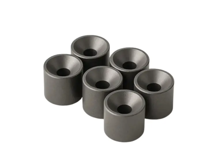 Close-up shot of precision-engineered tungsten carbide cones and spheres, used in various industrial applications like mining and drilling.